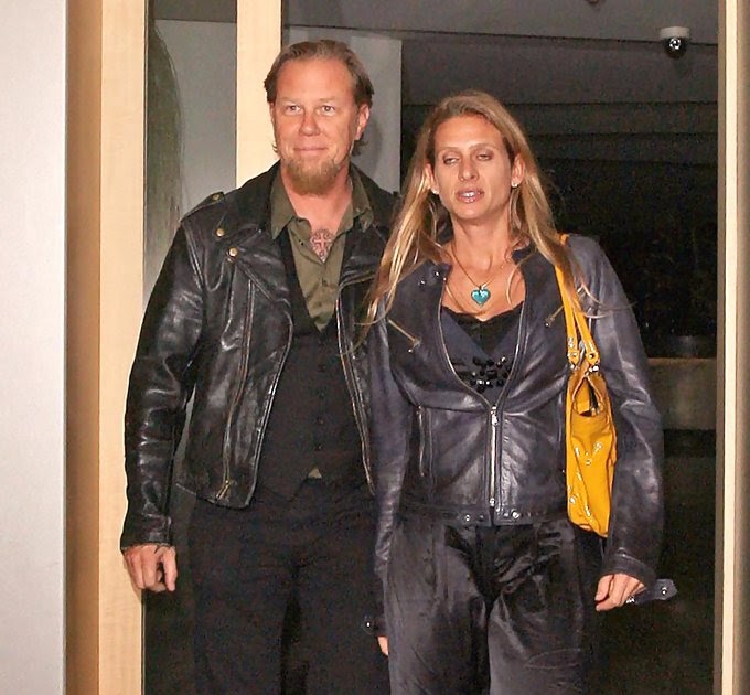 James Hetfield in a black leather jacker and pants with his  wife in similar dress. 